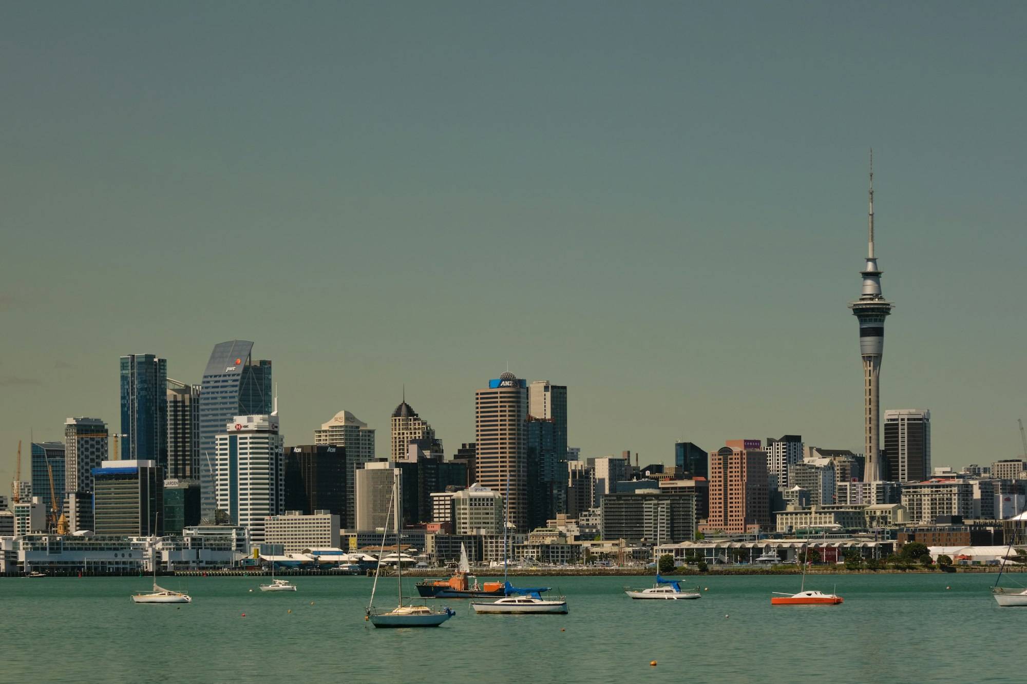 The Auckland city skyline seen across the water under a clear sky
