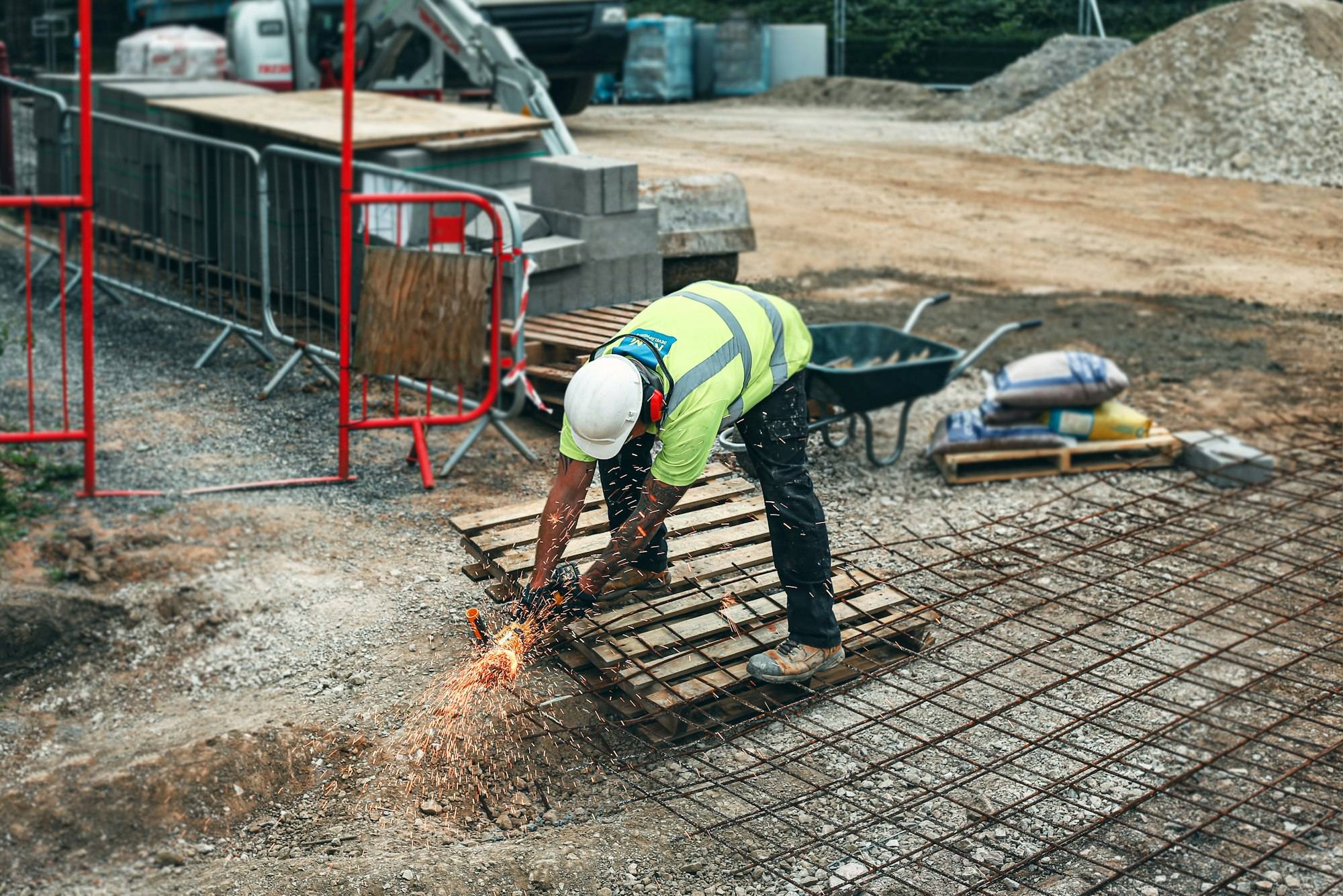 A builder in a hi-vis vest standing on a construction site